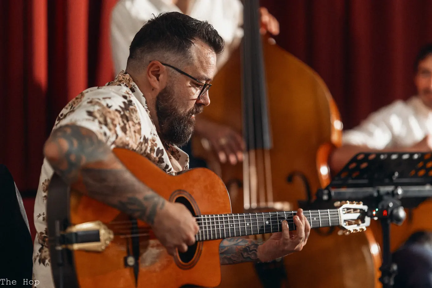 Guitarist playing with the upright bass behind him